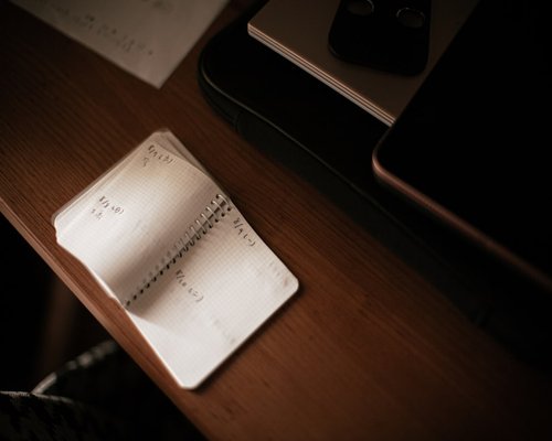 A neat desk with a closed notebook indicating the end of a workday